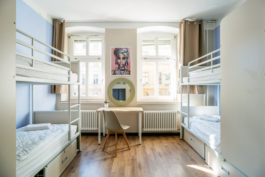 Bright, modern shared room at EastSeven Hostel Berlin with bunk beds and stylish decoration.