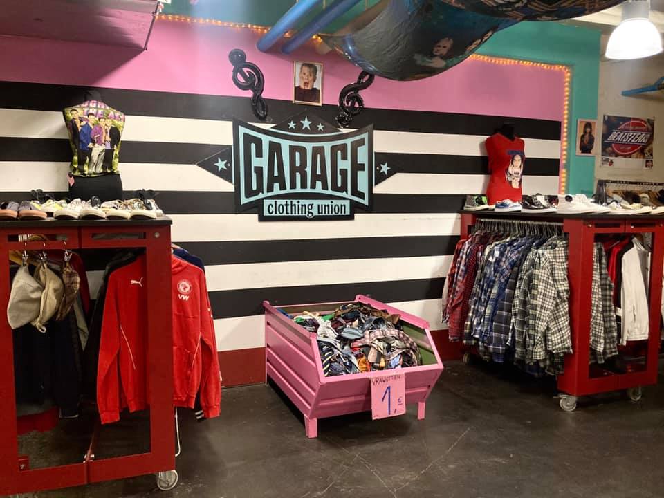 Colorful selection of clothing at Garage thrift shop Berlin, one of the city's best-known secondhand stores.