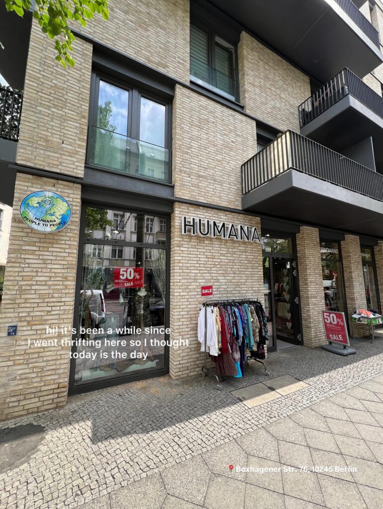Humana thrift shop Berlin on Boxhagener Straße with clothing racks and sale items.
