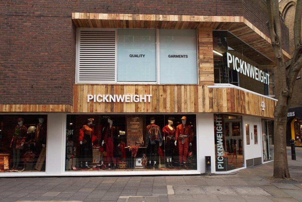 Exterior view of PicknWeight thrift shop Berlin with shop windows full of vintage fashion.